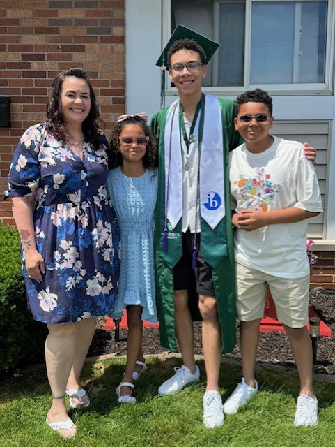  3 children , 1 with graduation gown, and a woman 